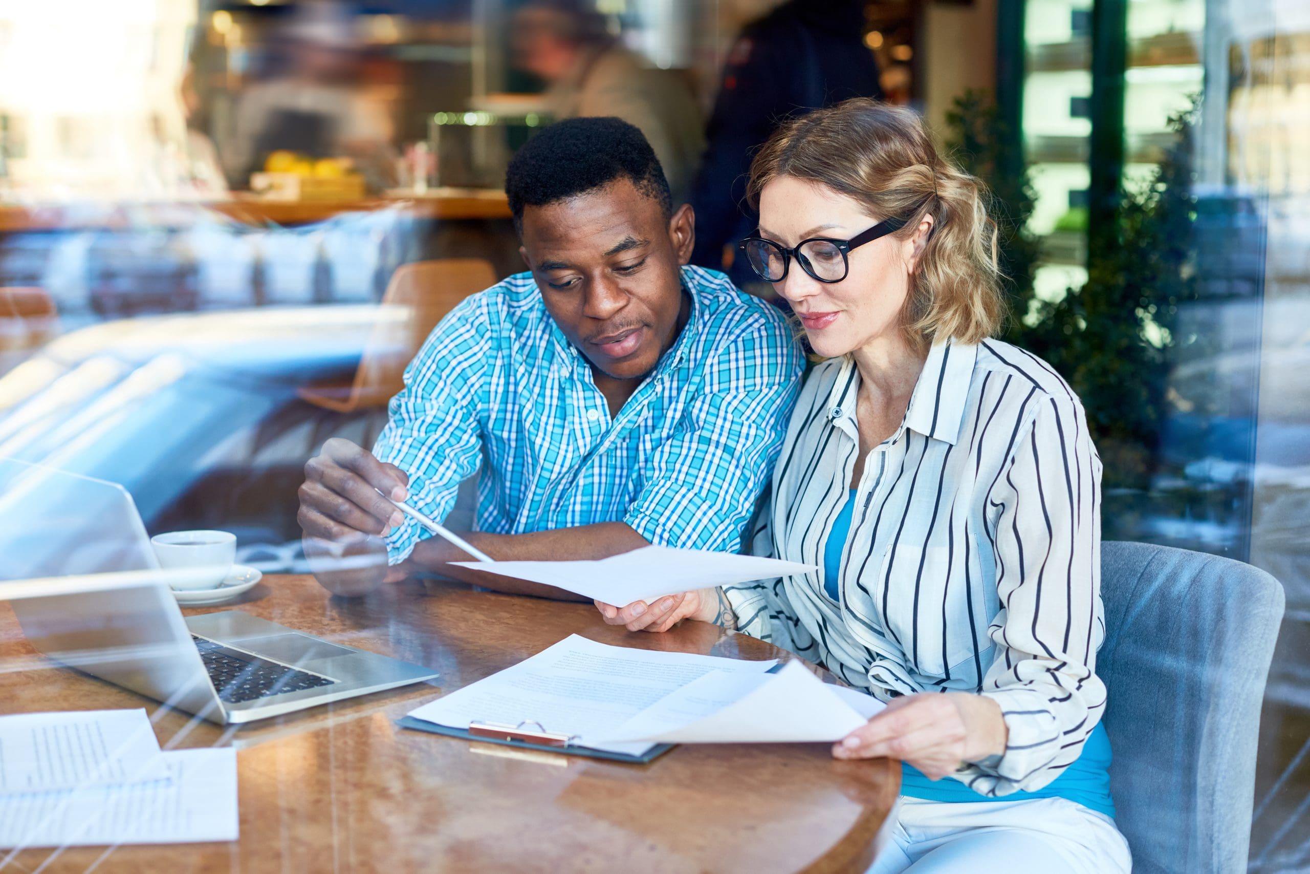 two coworkers looking at papers