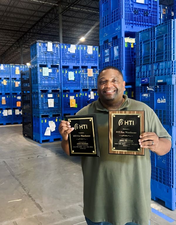 HTI employee at borgwarner warehouse with safety awards